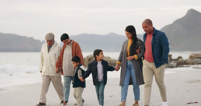 Family, walking on beach and holding hands, generations and travel by the ocean, trust and bonding outdoor. Winter, nature and grandparents with parents and children, adventure and freedom on journey