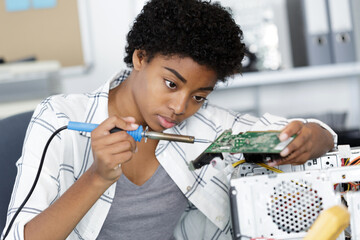 female engineer fixing broken computer hard drive