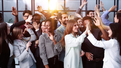 Supporters clapping at political gathering in the office