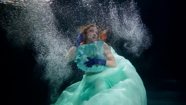 fabulous fairy floating underwater, mesmerizing figure of beautiful woman in dark depth