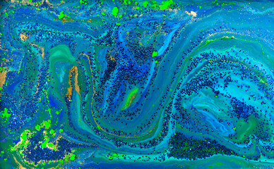 Fototapeta na wymiar Blue and Gold Glitter on Liquid Blue Ink Background.