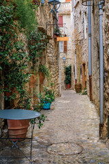Fototapeta na wymiar Traditional old stone houses on a narrow street in the medieval town of Saint Paul de Vence, French Riviera, South of France