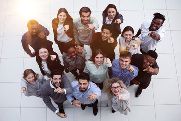 group of happy young business people looking up