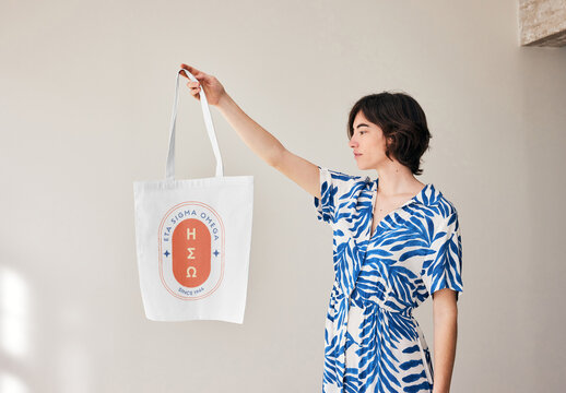 Mockup Of Woman Holding Customizable Tote Bag With Arm Out