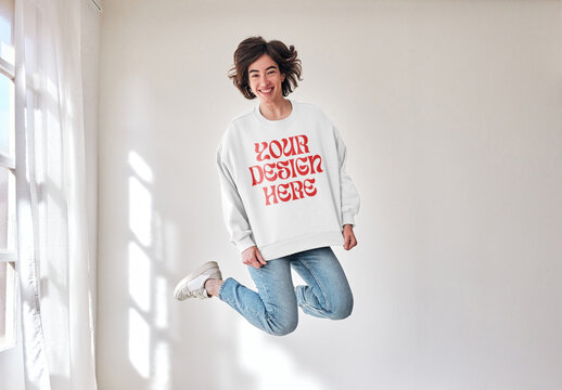 Mockup of woman wearing long sleeved top with customizable color, leaping mid air