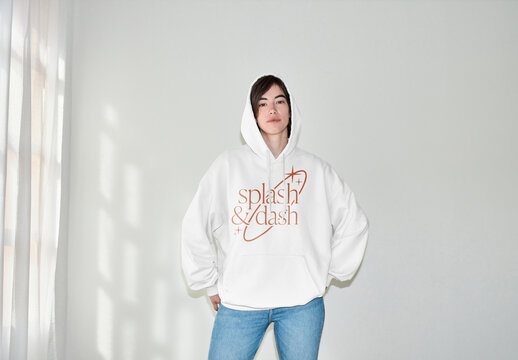 Mockup of woman wearing hoodie with hood up, front view, with customizable color