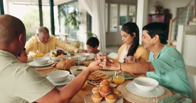 Family, holding hands and praying for lunch at table for worship, gratitude or spiritual faith. Prayer, food and parents, grandparents and children saying grace or thanks before eating brunch in home