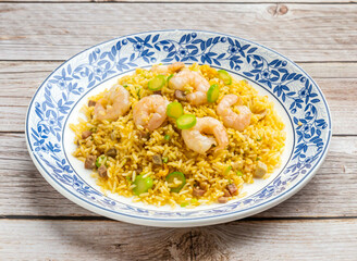 Shrimp fried rice in yeungzhou style served in dish isolated on wooden table top view hong kong food