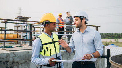 Professional Technician Ensuring Pollution Control in Wastewater Treatment Plant. Worker checking...