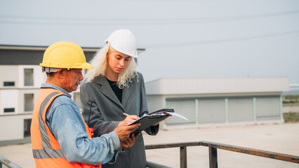 Team construction workers discussing project details. Professional Construction Team Meeting for Project Development.