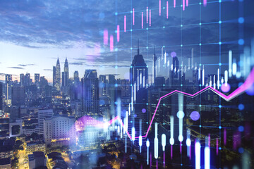Glowing candlestick forex chart on blurry city buildings wallpaper. Technology, trade and financial data concept. Double exposure.