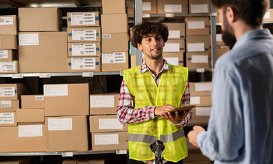 Retail storehouse employees doing inventory management. Postal service warehouse manager holding...