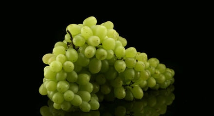 White grapes with drops of water, isolated on black background