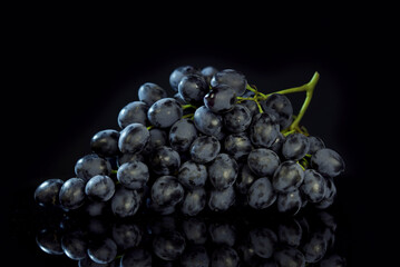 bunch of ripe dark grape isolated on black background