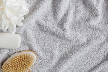 Top view of towel, sponge, soap and massage brush