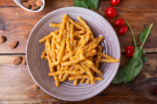Sicilian pasta with almond and tomatoes pesto. Typical Italian food from Sicily, pasta with red pesto.