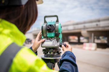 Portrait surveyors wearing uniform conversation and blueprint check inspection by theodolite camera to measurement level position road construction site is industry transportation concept