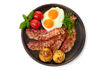 Cooked bacon rashers with egg, close-up, isolated on white background.