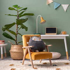 Creative composition of stylish and cozy child room interior design with green wall, plush toys, plant in basket; lamp, bright carpet, hut, desk, armchair, stool and lamp. Panels floor. Template...