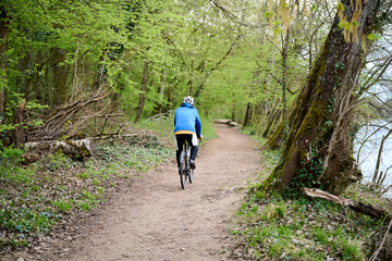 person riding a gravel bike on a forest road in France