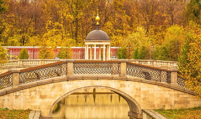 Autumn landscape with a picturesque bridge and chapel