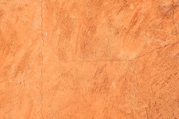 Cracked orange cement wall texture background.