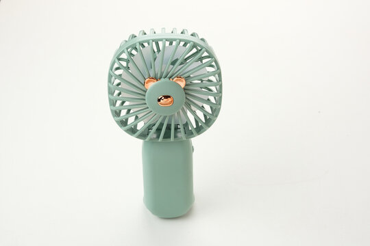 Mini electric fan with handle. Portable electrical equipment 
