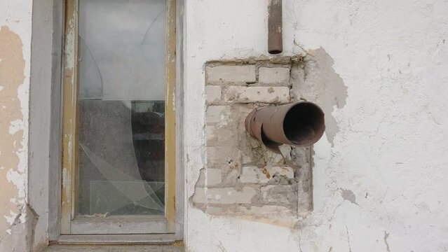 The big pipe sprouted outside the wall of the big house in Estonia