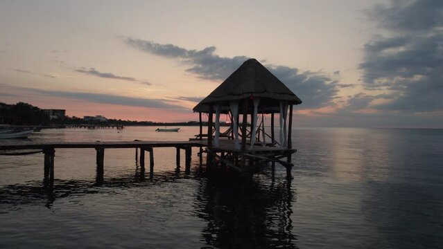 Aerial view of a beautiful wooden pier during sunset in Alea Tulum, Mexico.