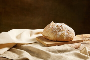 Composition with view from above of whole grain bread on rustic wooden board with tomatoes.