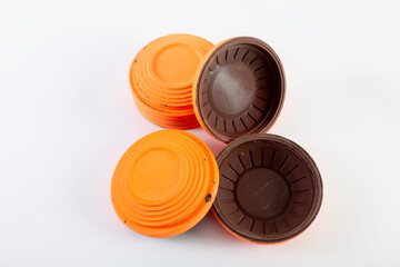 Orange skeet for trap shooting on white background..