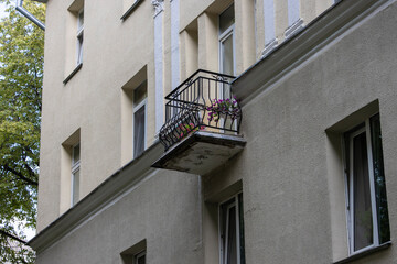 Fototapeta na wymiar Close-up of an old classic balcony with a wrought-iron railing in an old soviet apartment building
