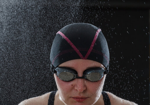 Portrait of  beautiful swimmer on black background