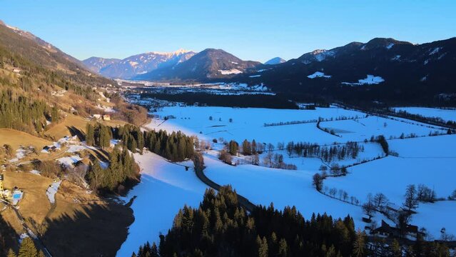 Aerial view of the Drava valley at sunset with snow in winter, Berg im Drautal, Carinthia, Austria.