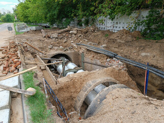 Dangerous unfenced dug hole by the road to repair old emergency water pipes