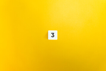 Number 3 on Letter Tile on Yellow Background. Minimal Aesthetic.