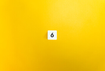 Number 6 on Letter Tile on Yellow Background. Minimal Aesthetic.