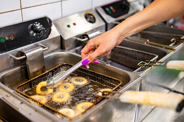 woman chef hand cooking Deep fried onion ring on kitchen