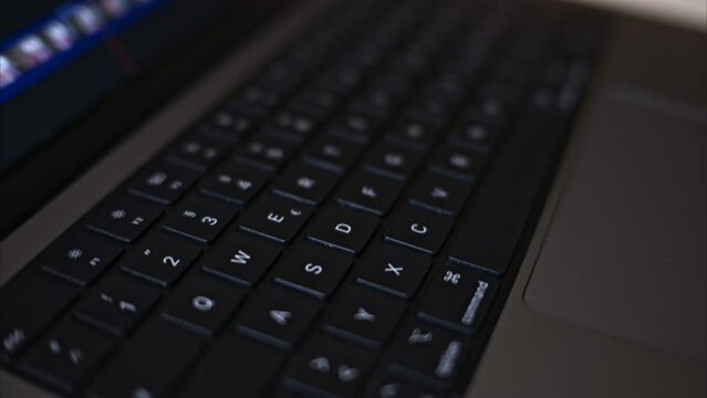 Close up black notebook keyboard with illuminated buttons
