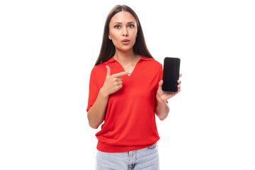 Fototapeta premium 30 year old active caucasian woman with straight dark hair dressed in red short sleeve shirt holding phone vertically with mockup