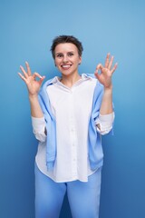 confident fashionable young lady with tousled hair in a white shirt in an informal setting