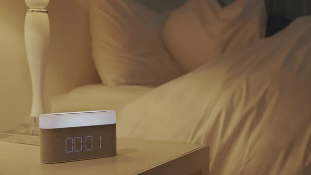 Anxious woman lying on bed is tossing and turning at midnight.