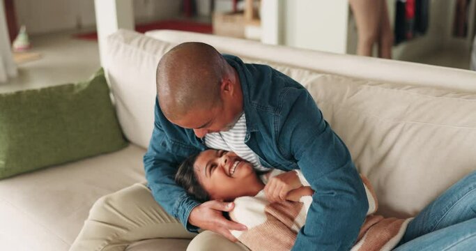 Home, family and dad tickle in living room with smile, love and parent care of fun, kid and father. Bonding, papa and together on house sofa laughing in lounge with funny joke and happy with child