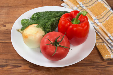 Various fresh vegetables as salad ingredients on the dish
