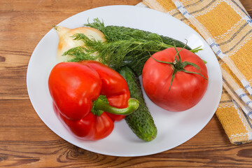 Various fresh vegetables as salad ingredients on the dish