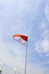 Indonesian flag fluttering under a clear blue sky