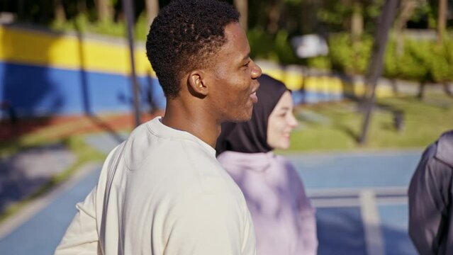 Multicultural friends gather at the sports field before training