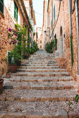 Fototapeta na wymiar View of a medieval street in the Old Town of the picturesque Spanish-style village Fornalutx, Majorca or Mallorca island