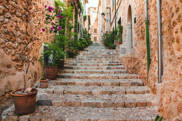 Fototapeta na wymiar View of a medieval street in the Old Town of the picturesque Spanish-style village Fornalutx, Majorca or Mallorca island