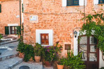 Fototapeta na wymiar View of a medieval street in the Old Town of the picturesque Spanish-style village Fornalutx, Majorca or Mallorca island